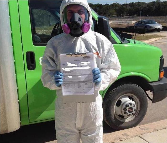 Man holding mold certificate